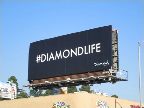 Black billboard which reads "#DIAMONDLIFE"